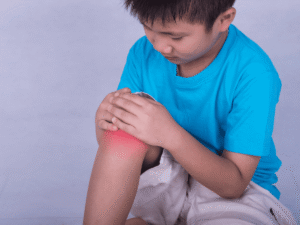 Pediatric orthopedist explaining meniscus tear care to a young patient’s parent at POBAR clinic in Brandon