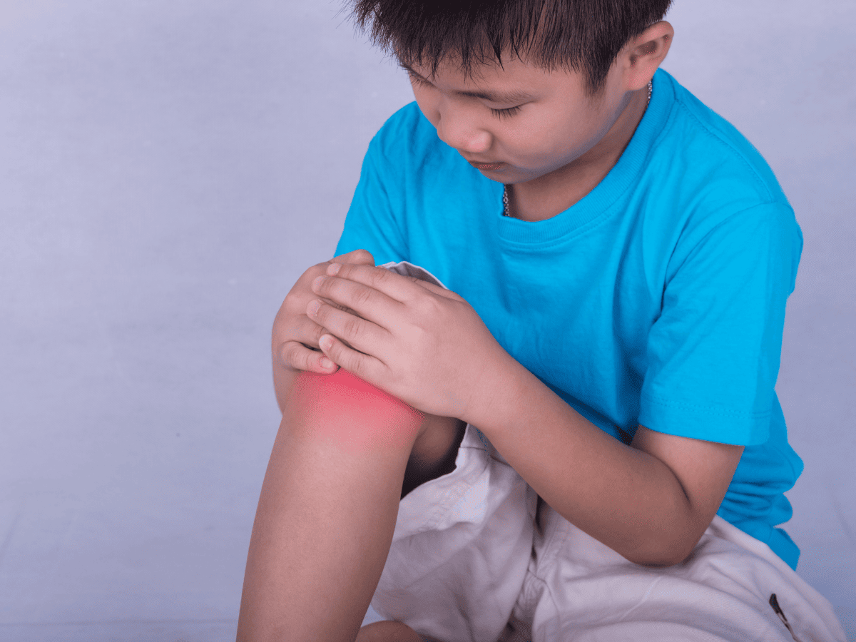 Pediatric orthopedist explaining meniscus tear care to a young patient’s parent at POBAR clinic in Brandon